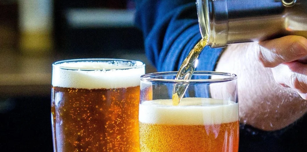 Man Pouring Beer into Glass for Beverage Equipment Distributor