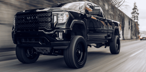 Auto Parts Distributor GMC Truck Driving on Open Road