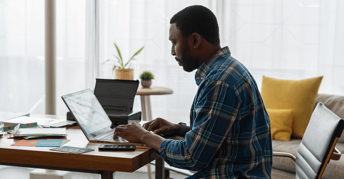 man typing on laptop using a b2b ecommerce portal